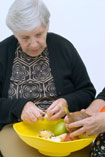Woman peeling and chopping apples after occupational therapy made it possible